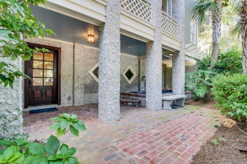 a house with a brick walkway in front of a door at Beach cottage with private pool & spa, ocean views, & shared pool access in Saint Simons Island
