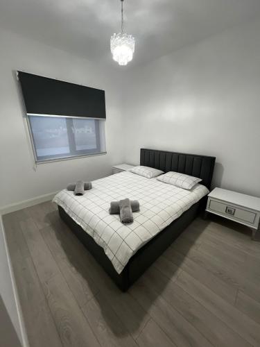 a bedroom with a large bed with two pillows on it at Gosen Grand Residence in Sângeorz-Băi