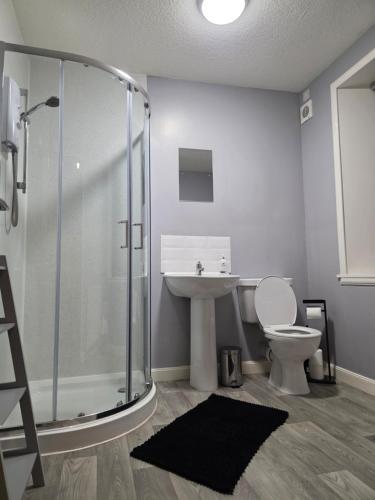 a bathroom with a shower and a toilet and a sink at Wick Harbour View Apartment - 2 Beds - Sleeps 3 - Ideal for Couples in Wick