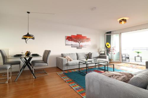 a living room with a couch and a table at Suite im Zentrum Süd-Balkon Parken in Bad Lippspringe