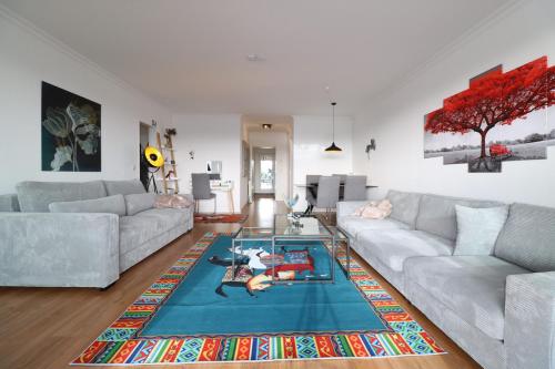 a living room with two couches and a glass table at Suite im Zentrum Süd-Balkon Parken in Bad Lippspringe
