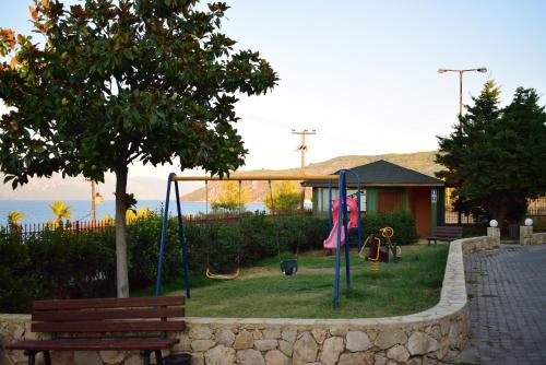 a playground with a bench and a swing at Villa Eugenia in Theológos