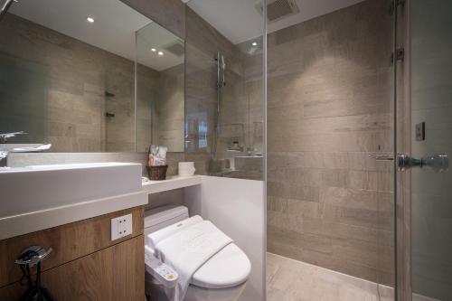a bathroom with a shower and a toilet and a sink at Hotel Relax 5 in Taipei