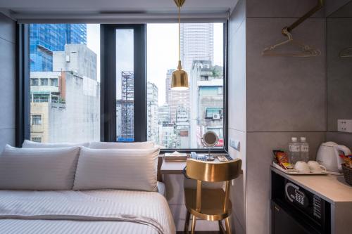 a bedroom with a bed and a large window at Hotel Relax 5 in Taipei