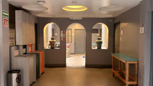 a hallway with arched ceilings and a hallway with a room withapons at Hotel Sonora, Centro Histórico in Mexico City