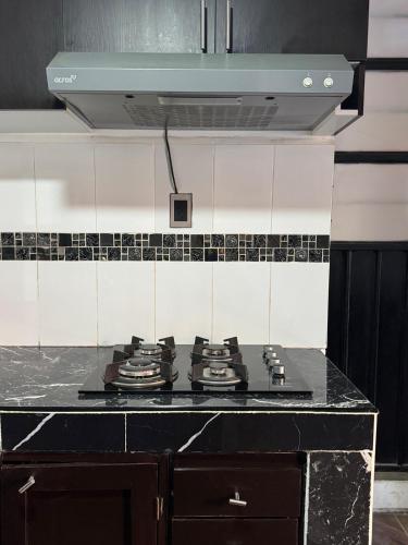 a stove top in a kitchen with at Minimalist loft 3 blocks from the Zócalo in Oaxaca City
