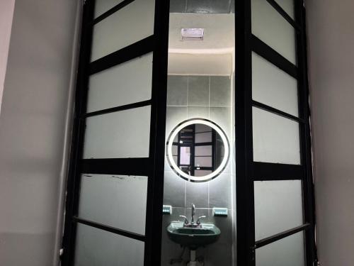 a bathroom with a sink and a mirror at Minimalist loft 3 blocks from the Zócalo in Oaxaca City