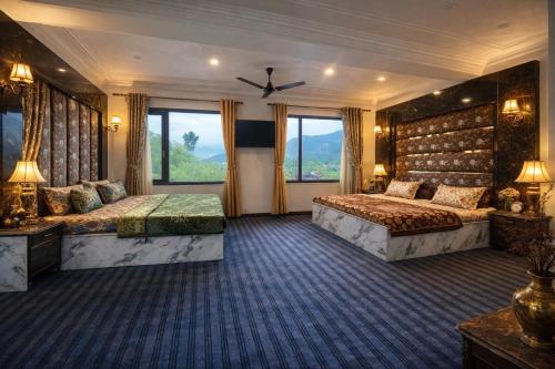 a hotel room with two beds and two windows at Lake side stays in Srinagar