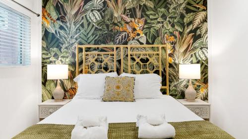 a bedroom with a bed with a floral wallpaper at Urban Jungle by AvantStay in Los Angeles