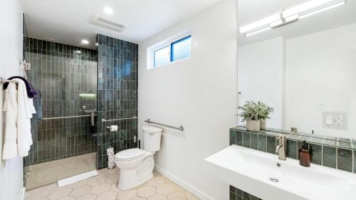 a bathroom with a toilet and a sink and a shower at Urban Jungle by AvantStay in Los Angeles