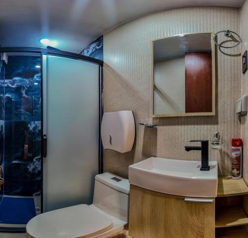a bathroom with a toilet and a sink and a shower at Apartment E18 UPAO 2nd Floor in Trujillo