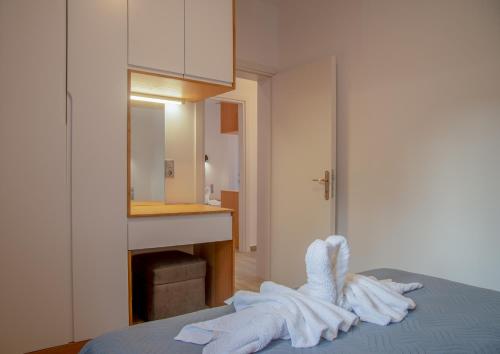 a room with towels on a bed with a sink at Villa Voka in Acharavi