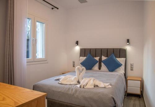 a bedroom with a bed with towels on it at Villa Voka in Acharavi
