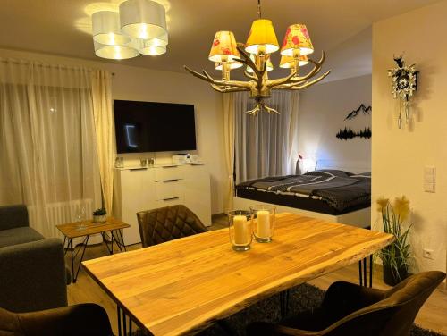 a living room with a table and a bed at Ferienwohnung Waldrose am Titisee in Titisee