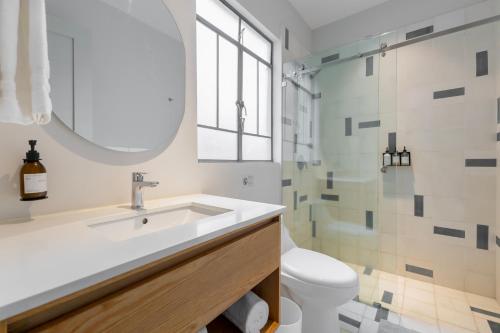 a bathroom with a sink and a toilet and a shower at Capitalia Nuevo Polanco in Mexico City