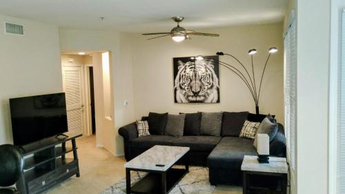 a living room with a couch and a picture of a tiger at COZY 2BR/2BA ! 5MINtoDisney ! AngelStadium!HondaCenter in Anaheim