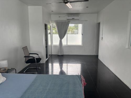 a white room with a bed and a window at casa di george in Iririki Island
