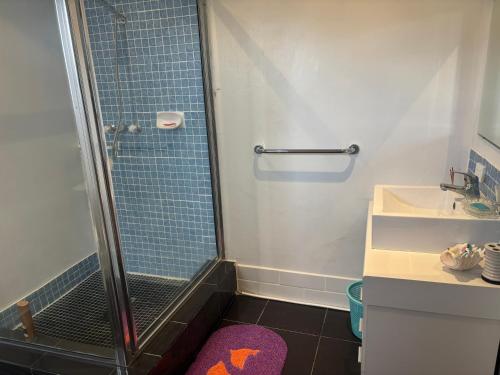 a bathroom with a shower and a sink at casa di george in Iririki Island