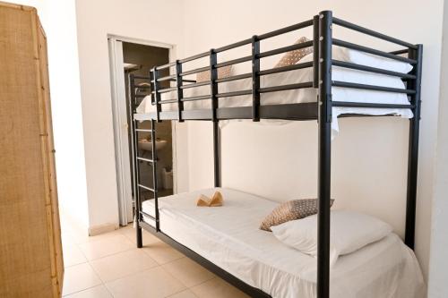 a bunk bed in a small room with a bunk beduteneway at Il-Qastna Holiday House in Żejtun