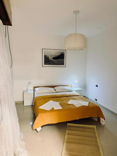 a bedroom with a bed in a white room at Villa Mare & Monti in Genoa