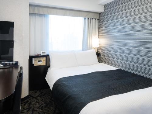 a hotel room with two beds and a window at APA Hotel Akihabara Ekihigashi in Tokyo