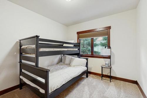 a bedroom with a bunk bed and a window at Blue River Retreat in Silverthorne