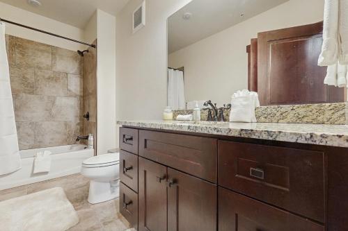 a bathroom with a sink and a toilet and a tub at Blue River Retreat in Silverthorne