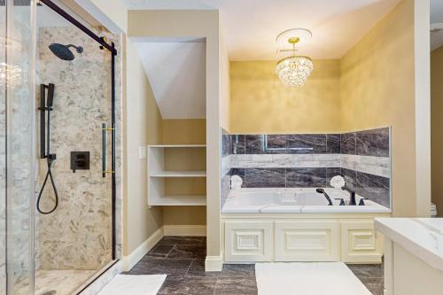 a bathroom with a tub and a shower at Steps to Holyoke Medical Center! Remote-Work Hub in Holyoke