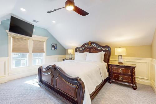 a bedroom with a large bed and a flat screen tv at Steps to Holyoke Medical Center! Remote-Work Hub in Holyoke