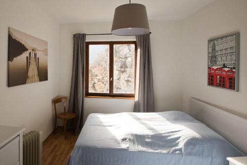 a bedroom with a bed and a window at Casa Onsernone in Comologno in Comologno