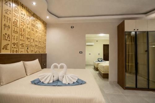 a bedroom with two swans on a bed at Pyraking Pyramids View Hotel in Giza
