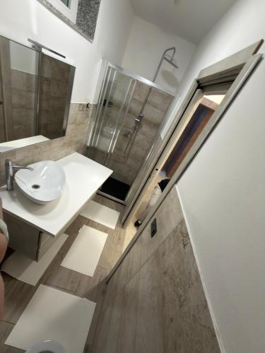 a bathroom with a sink and a shower and a toilet at Villa Mare & Monti in Genoa