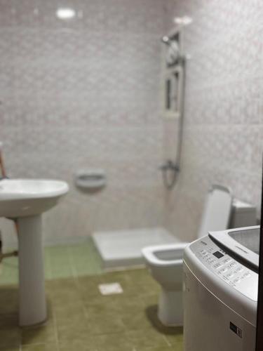a bathroom with a toilet and a sink at أجاويد 1 Ajaweed in Salalah