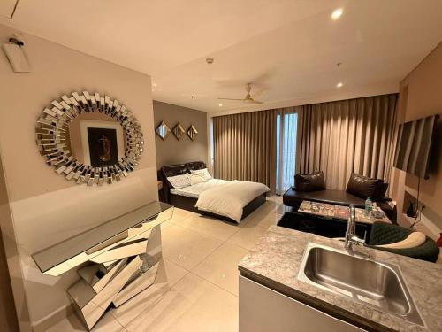 a kitchen and living room with a sink and a bed at Luxury Studios Key 1 in Gurgaon
