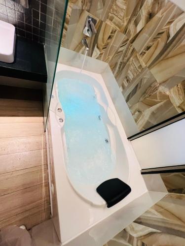 a jacuzzi tub in a bathroom at Luxury Studios Key 1 in Gurgaon