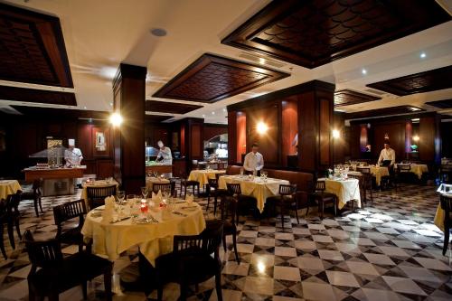 a dining room with tables and people in a restaurant at Stella Di Mare Beach Hotel & Spa in Sharm El Sheikh