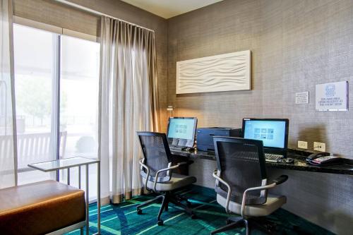 an office with two computers and a desk with chairs at SpringHill Suites By Marriott Erie in Erie