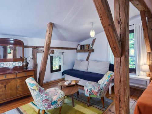 a living room with a blue couch and chairs at Large holiday home, summer pool, sauna, whirlpool in Sasino