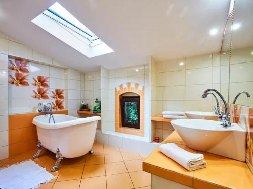 a bathroom with two sinks and two tubs at Large holiday home, summer pool, sauna, whirlpool in Sasino