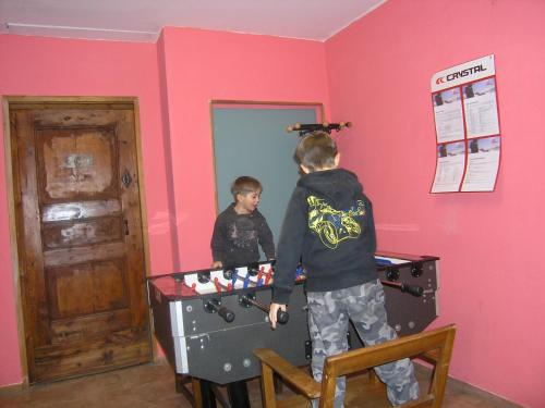 a young boy playing a video game at a ping pong table at Hotel Martin in Sauze dʼOulx