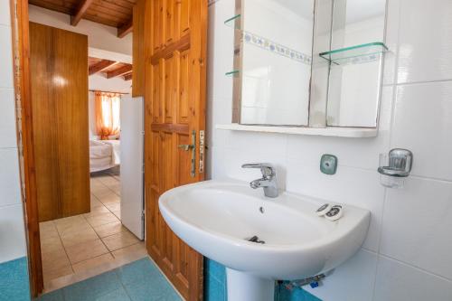 a bathroom with a sink and a mirror at Maria Apartments in Amoopi