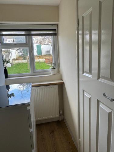 an empty room with a door and a window at North West Lodge Guest House in London