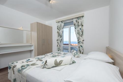 Posteľ alebo postele v izbe v ubytovaní Paradis Apartments