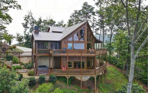 a large wooden house on a hill with trees at Majestic Mountaintop Escape in Blue Ridge