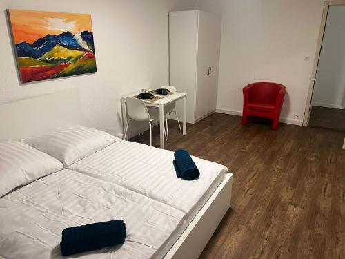 a bedroom with a bed and a table and a chair at Central Living Brugg - Studio 11 in Brugg