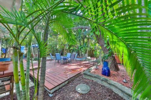 a backyard with a wooden deck with chairs and trees at Garden botanical Villa with jacuzzi in Hollywood