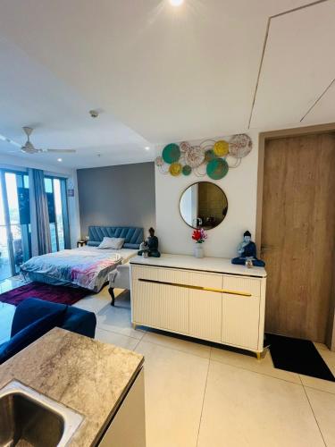 a bedroom with a bed and a mirror on the wall at Luxury Studios Key 7 in Gurgaon
