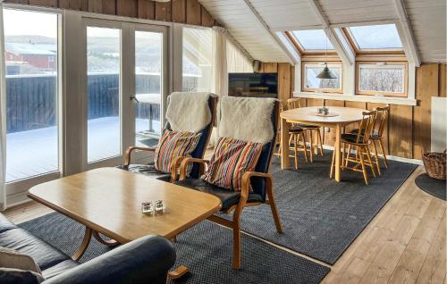 a living room with chairs and a table at Holiday Home Hvide Sande 20 in Bjerregård