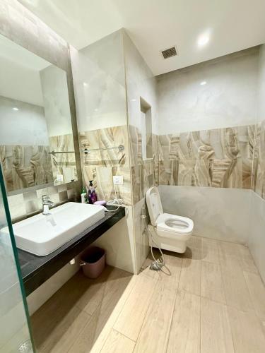 a bathroom with a sink and a toilet at Luxury Studios Key 7 in Gurgaon