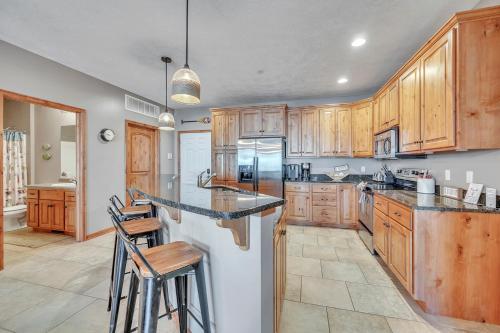 a kitchen with wooden cabinets and bar stools at Bridges Bay Resort Coronado Building 302 in Arnolds Park